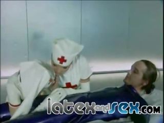 Latex nurses treat a rubber gas mask guy